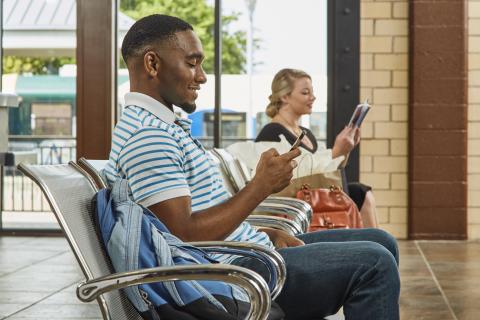 Man and woman sitting at Downtown Denton Transit Center